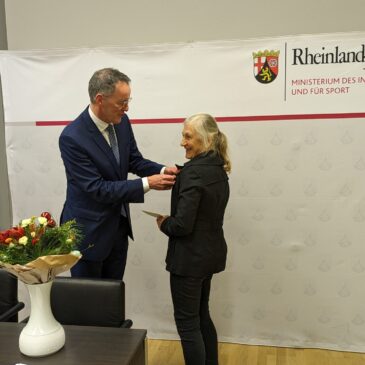 Innenminister Michael Ebling überreicht Ulla Brede-Hoffmann das Bundesverdienstkreuz